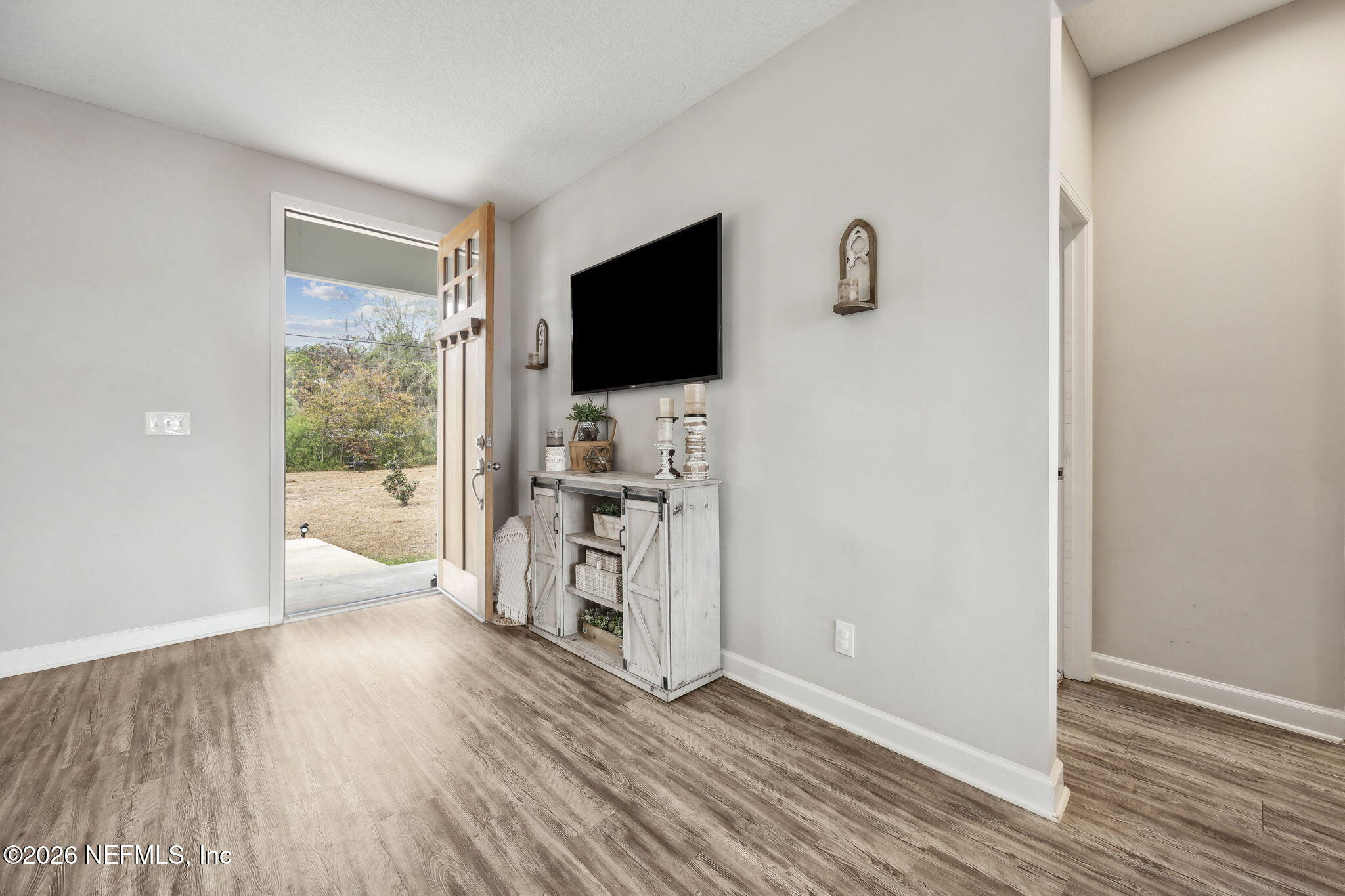 96718 Blackrock Road Yulee, FL 32097 - Photo 15 of 54 a view of a livingroom with wooden floor and a flat screen tv
