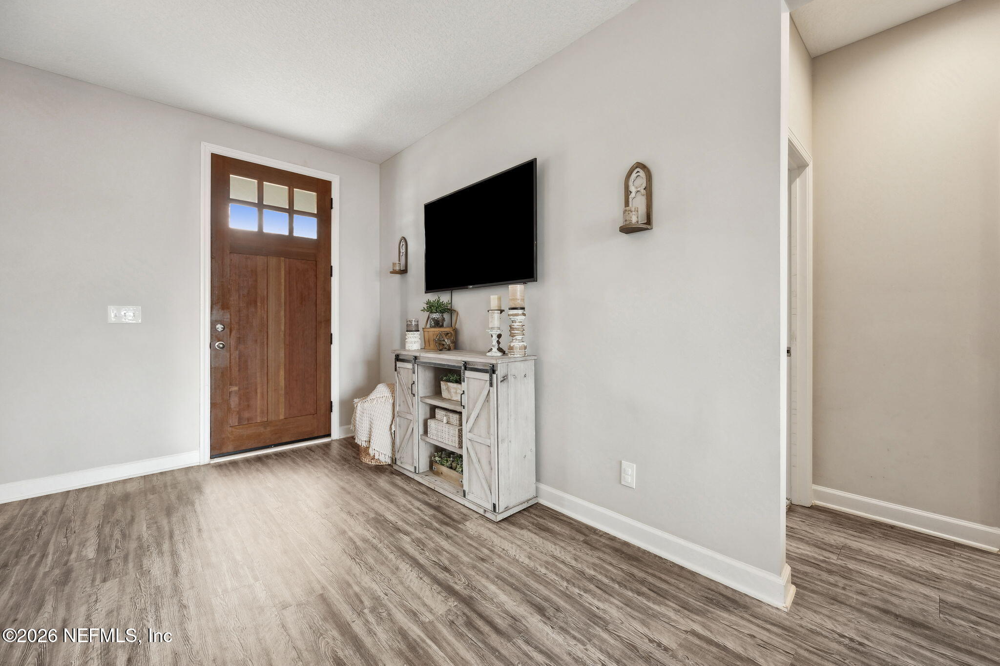 96718 Blackrock Road Yulee, FL 32097 - Photo 16 of 54 a view of a livingroom with wooden floor and a flat screen tv