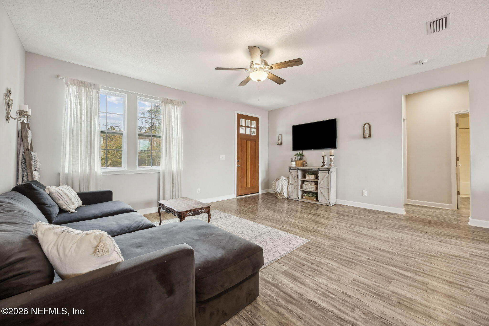 96718 Blackrock Road Yulee, FL 32097 - Photo 17 of 54 a living room with furniture and a flat screen tv