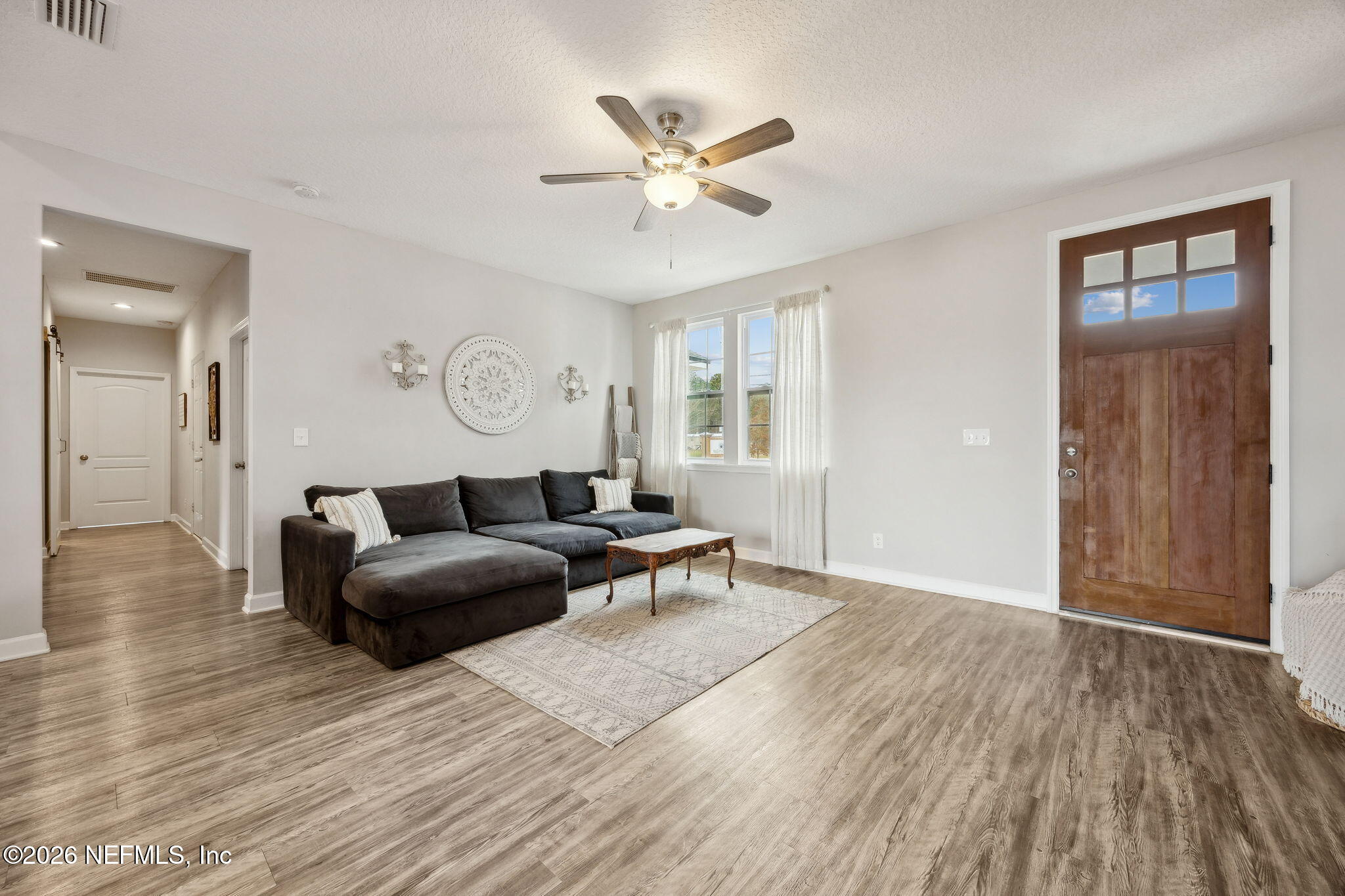 96718 Blackrock Road Yulee, FL 32097 - Photo 18 of 54 a living room with furniture and a large window