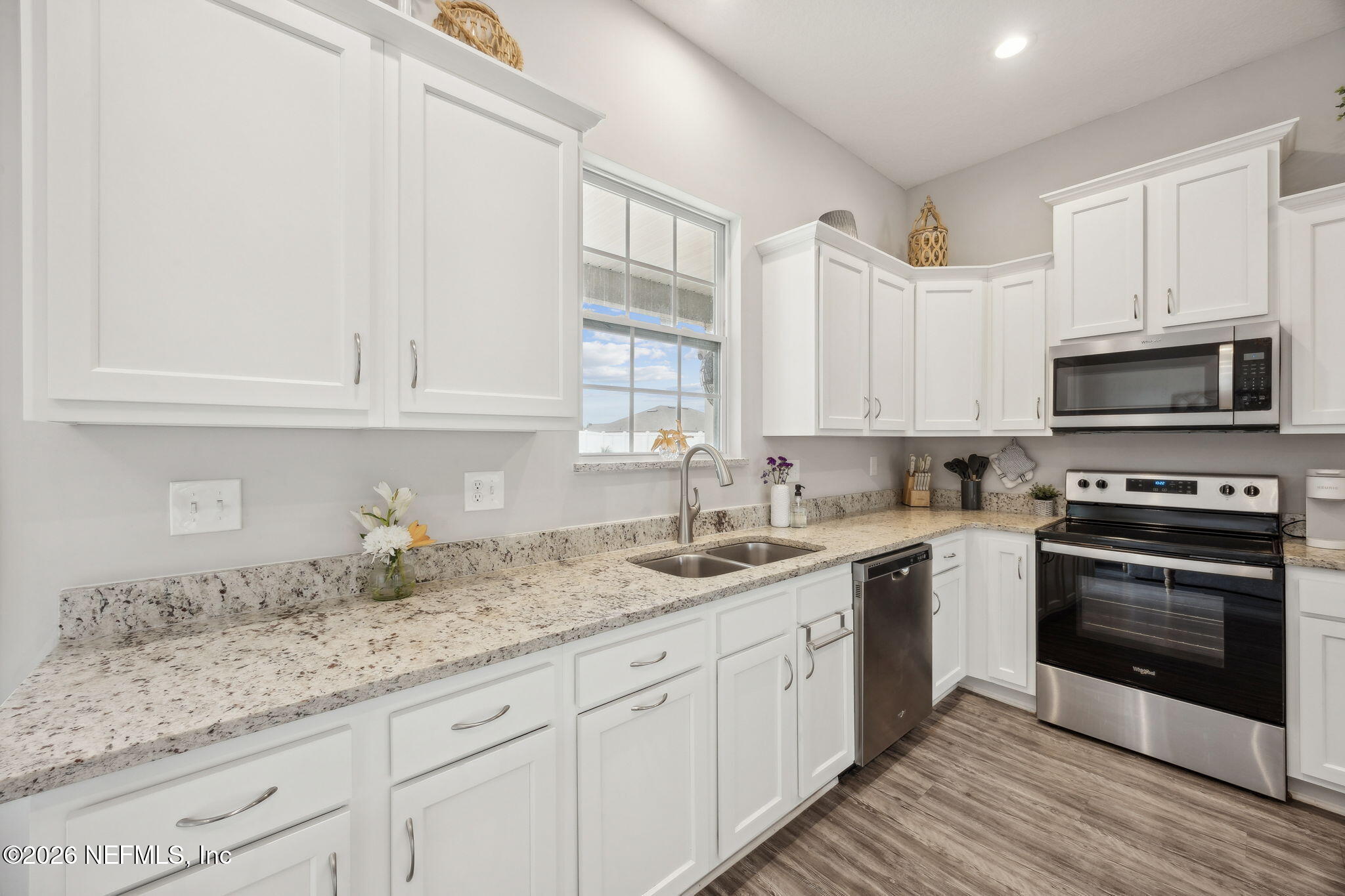 96718 Blackrock Road Yulee, FL 32097 - Photo 22 of 54 a kitchen with granite countertop white cabinets stainless steel appliances and a sink