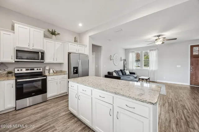a kitchen with stainless steel appliances a stove a microwave and a counter space