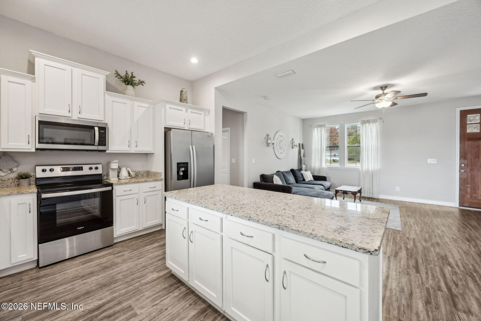 96718 Blackrock Road Yulee, FL 32097 - Photo 23 of 54 a kitchen with stainless steel appliances granite countertop a stove and a sink