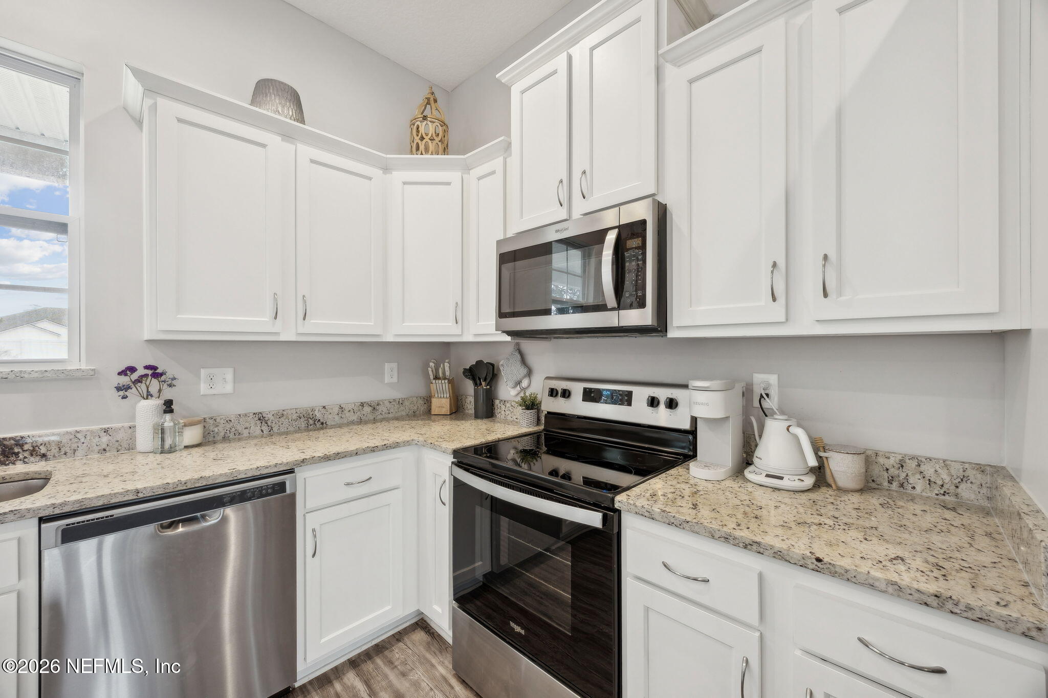 96718 Blackrock Road Yulee, FL 32097 - Photo 25 of 54 a kitchen with stainless steel appliances granite countertop white cabinets sink and dishwasher