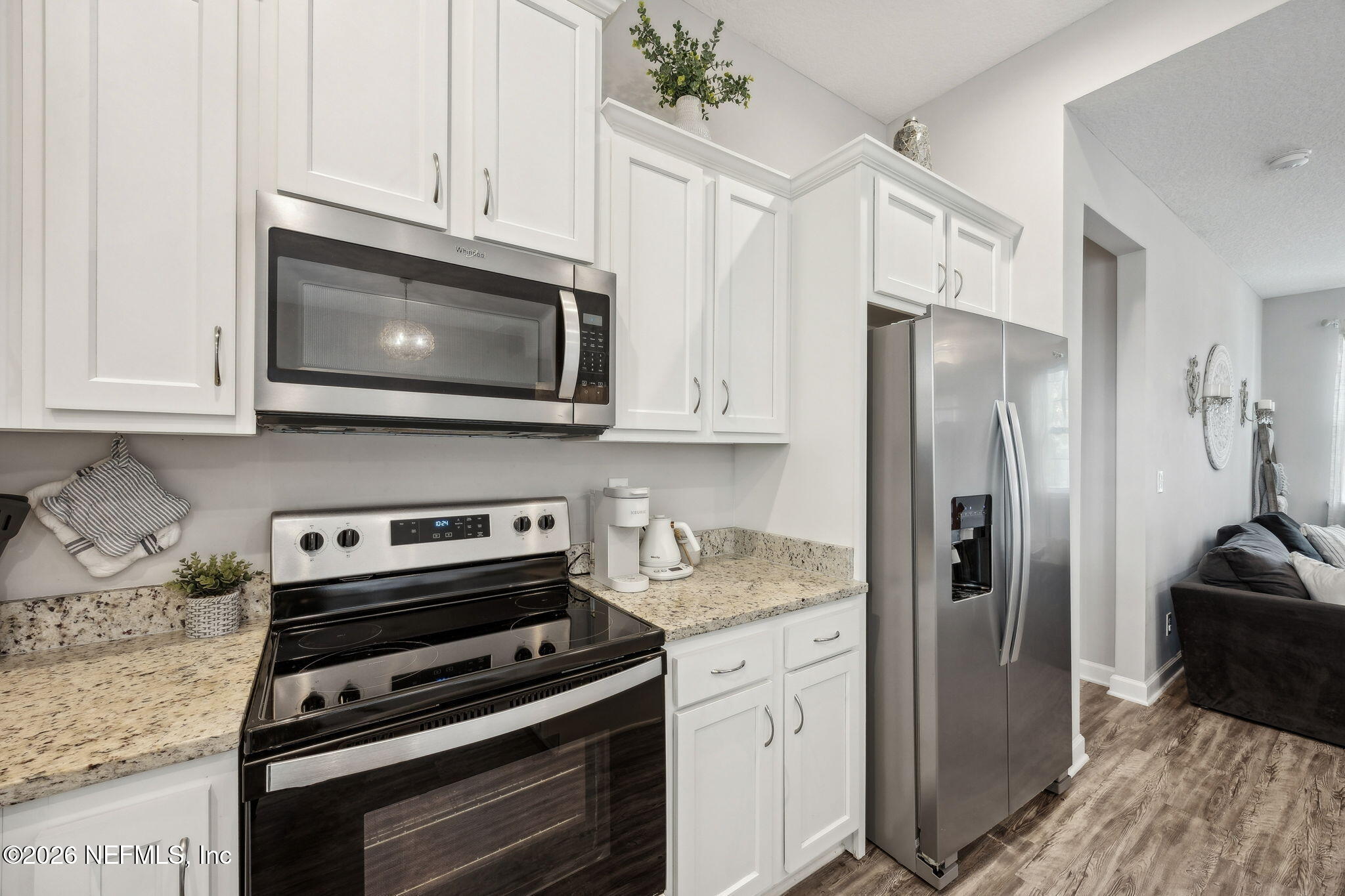 96718 Blackrock Road Yulee, FL 32097 - Photo 26 of 54 a kitchen with stainless steel appliances a stove a microwave and a counter space