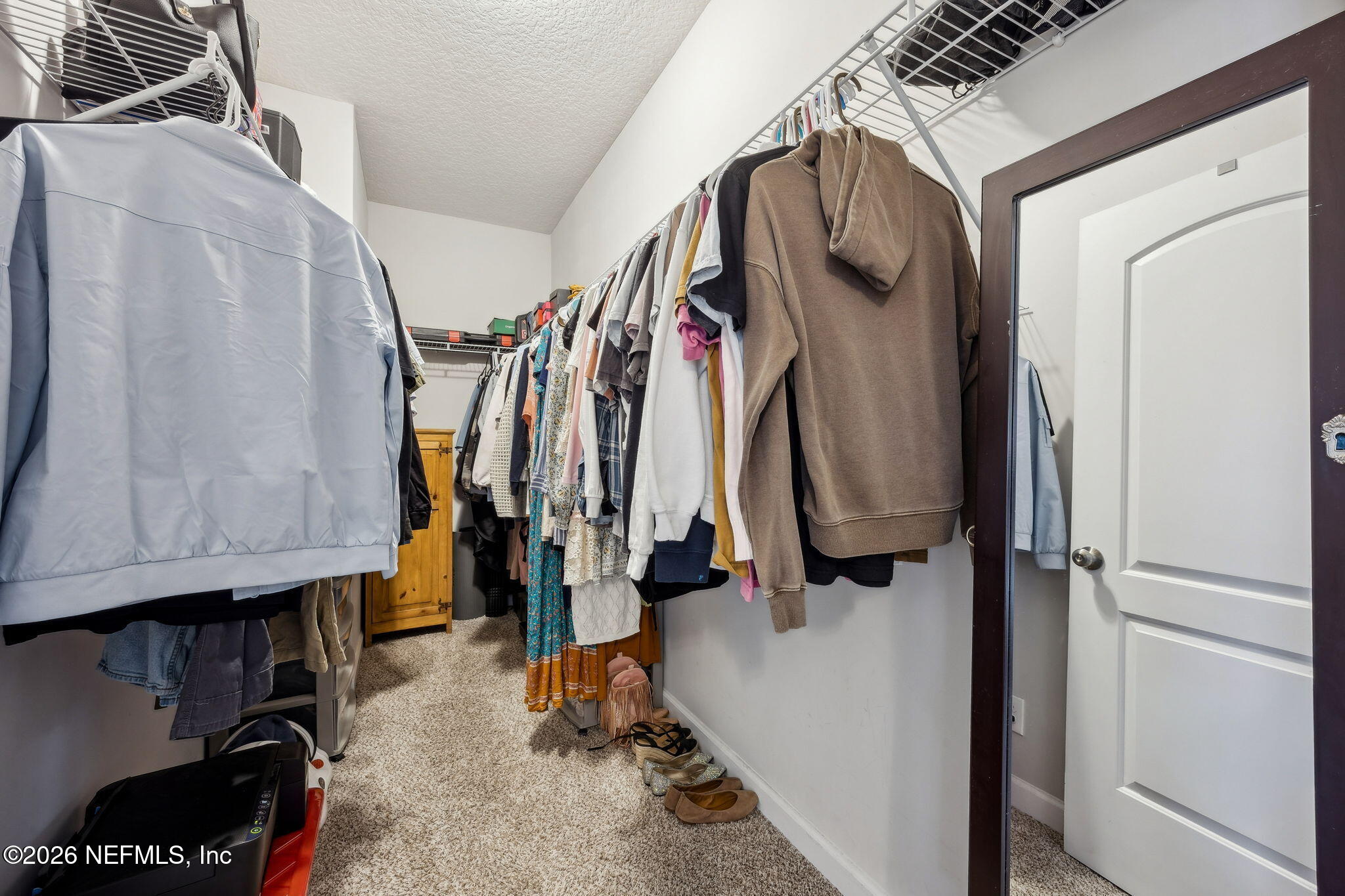 96718 Blackrock Road Yulee, FL 32097 - Photo 36 of 54 a view of walk in closet with clothes and shoes