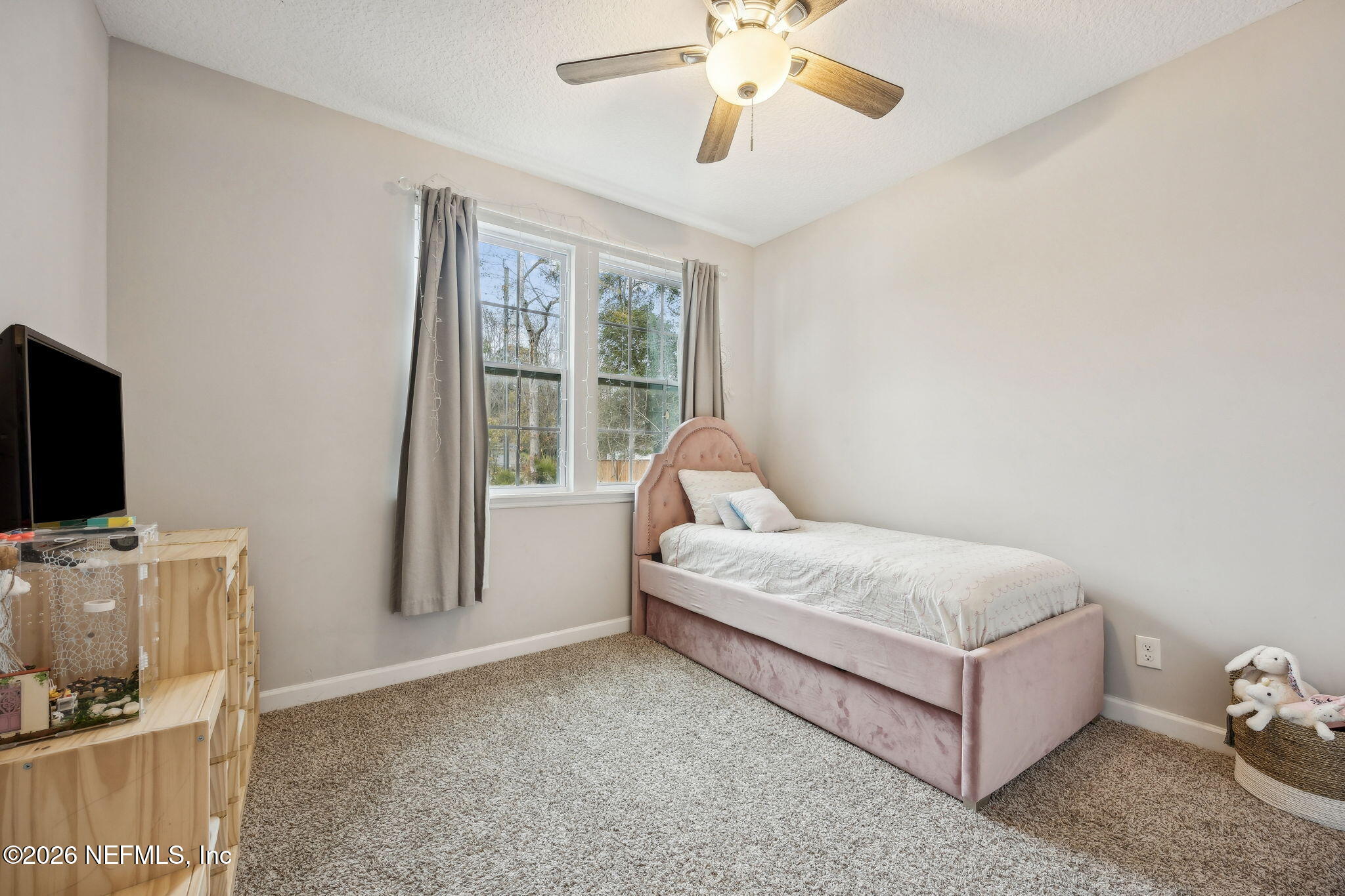 96718 Blackrock Road Yulee, FL 32097 - Photo 37 of 54 a spacious bedroom with a bed and a flat screen tv