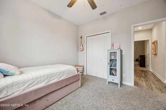 a living room with furniture and a ceiling fan