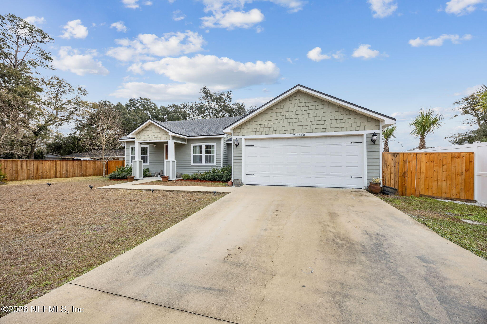96718 Blackrock Road Yulee, FL 32097 - Photo 9 of 54 a front view of a house with a yard and garage