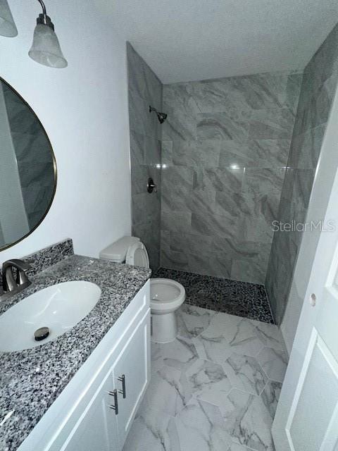 628 Northwest 2nd Street Ocala, FL 34475 - Photo 3 of 7 a bathroom with a granite countertop sink a toilet and shower