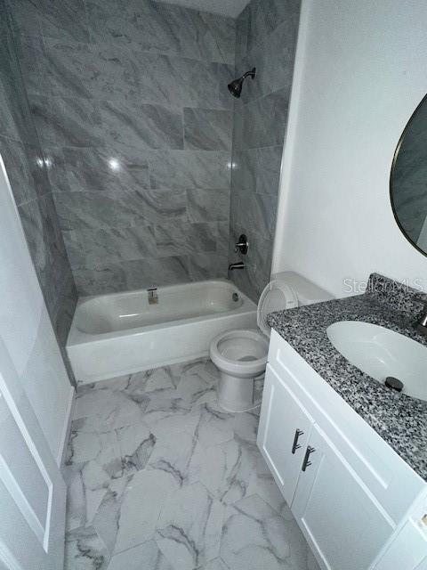 628 Northwest 2nd Street Ocala, FL 34475 - Photo 4 of 7 a bathroom with a granite countertop toilet a sink and bathtub