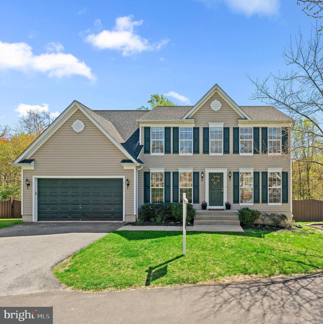 9531 Rommel Drive Columbia, MD 21046 - Photo 1 of 54 a front view of a house with a yard and garage