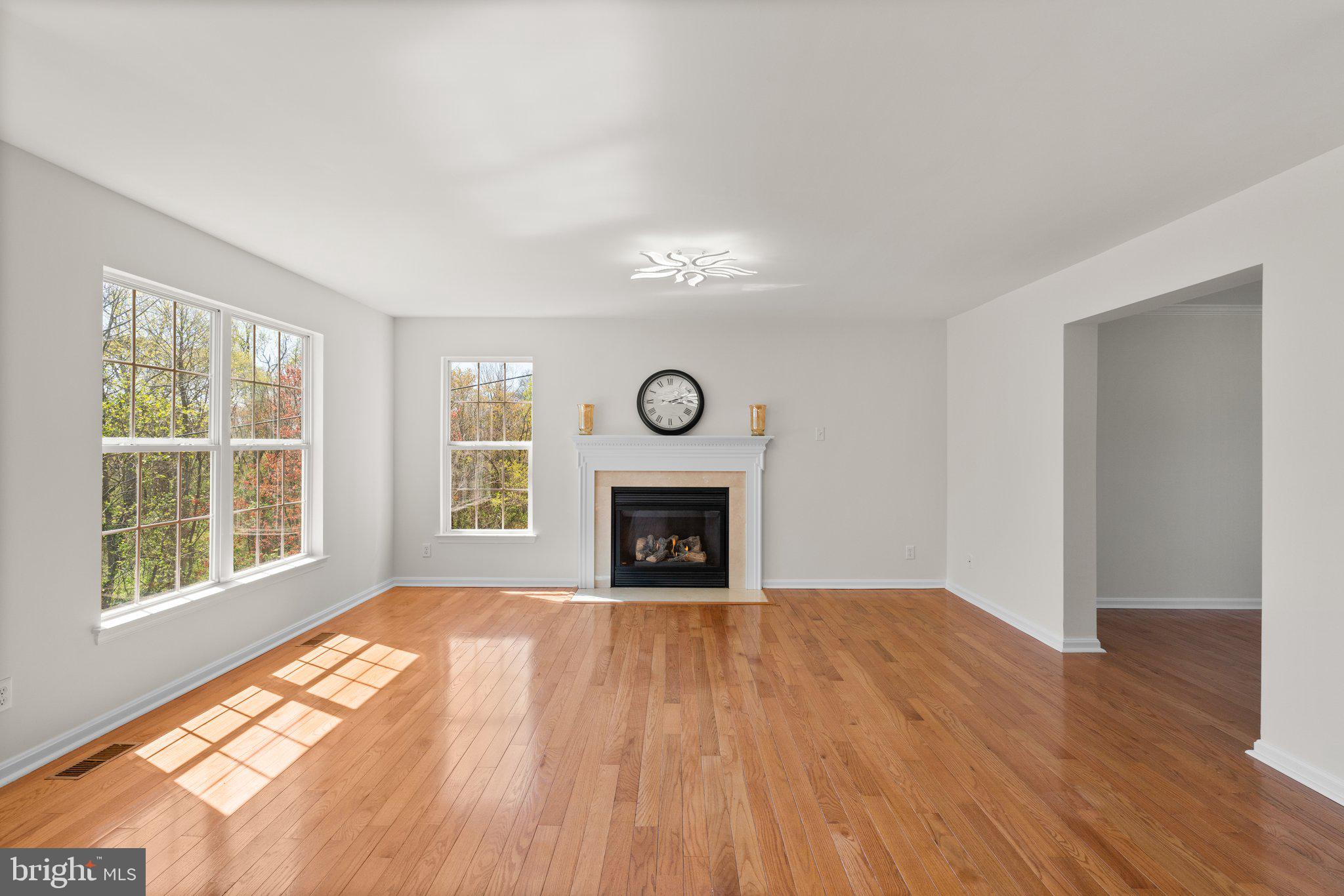 9531 Rommel Drive Columbia, MD 21046 - Photo 13 of 54 a view of an empty room with a window and wooden floor