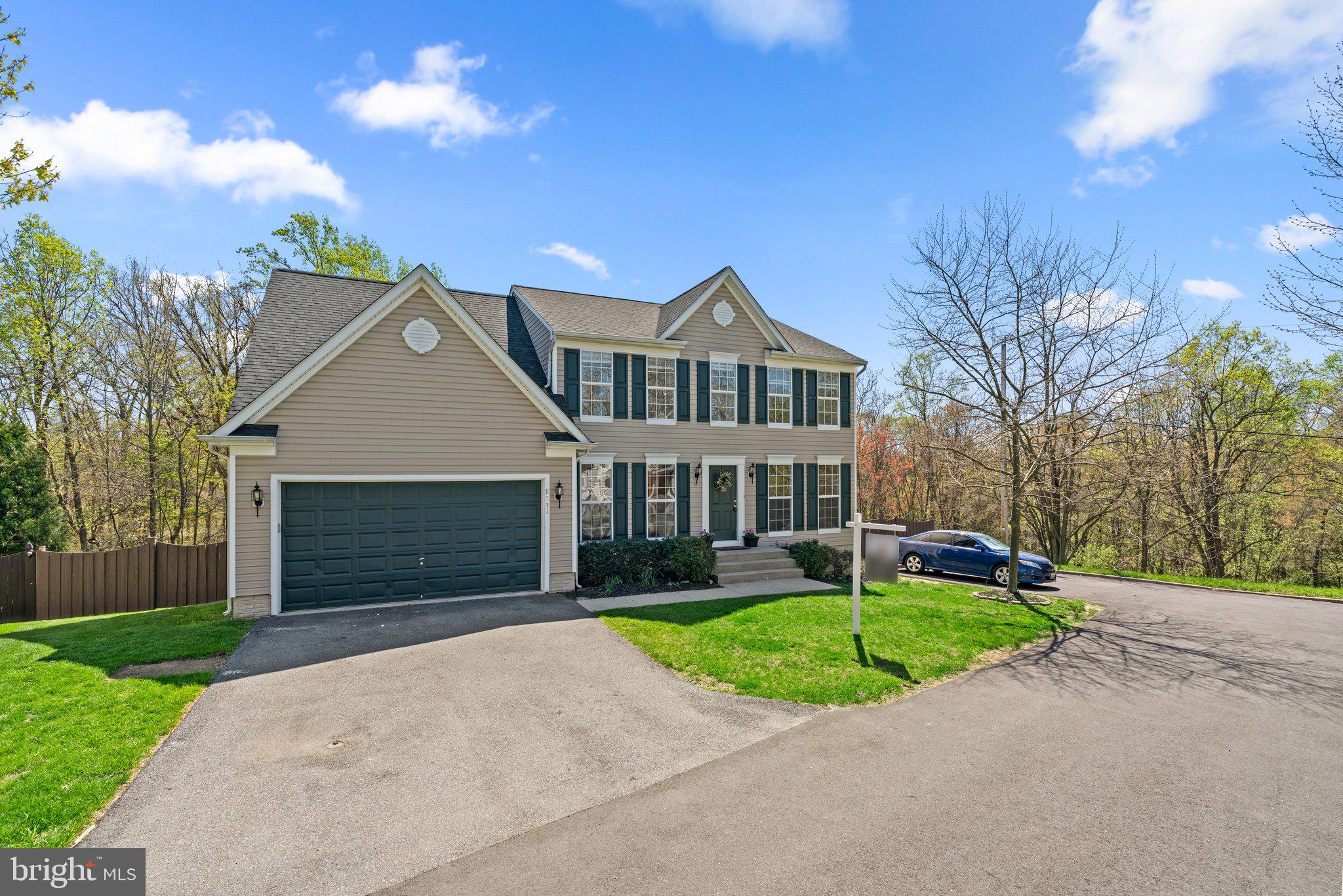9531 Rommel Drive Columbia, MD 21046 - Photo 2 of 54 a front view of a house with a yard and garage