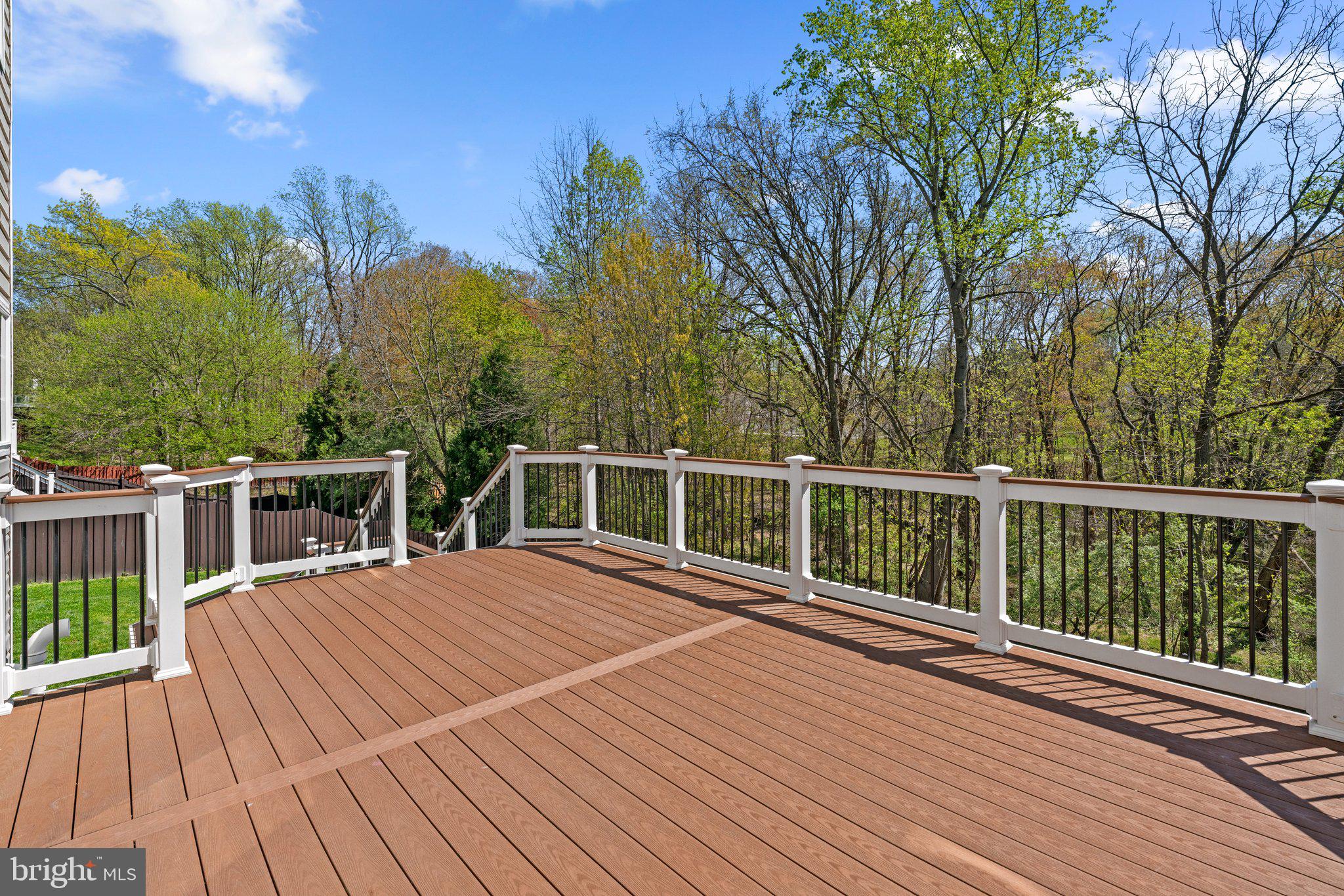 9531 Rommel Drive Columbia, MD 21046 - Photo 45 of 54 a view of a wooden deck and trees