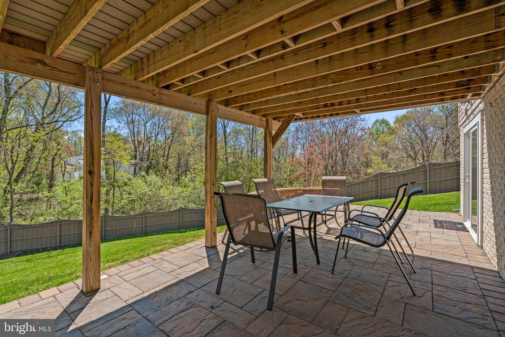 9531 Rommel Drive Columbia, MD 21046 - Photo 50 of 54 a view of a patio with table and chairs and wooden floor next to a yard