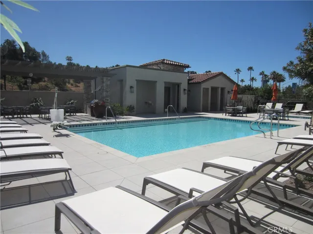 a view of a house with pool and chairs