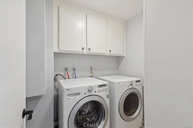 a view of storage and utility room with washer and dryer