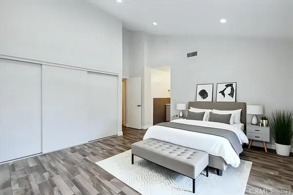 a spacious bedroom with a bed and a table