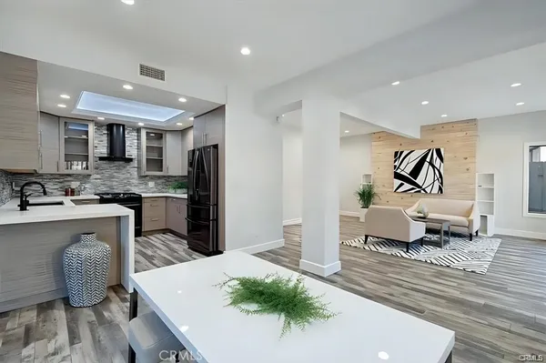 a living room with stainless steel appliances kitchen island granite countertop furniture and a kitchen view