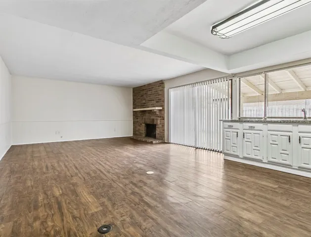 wooden floor in an empty room with a fireplace
