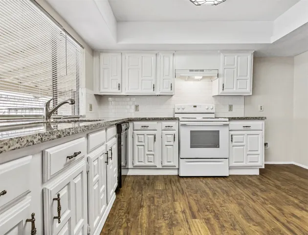 a kitchen with stainless steel appliances cabinets a sink and a stove