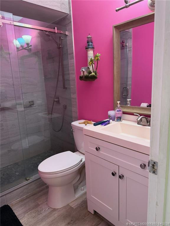 1225 Northwest 21st Street, Unit 3211 Stuart, FL 34994 - Photo 13 of 33 a bathroom with a sink toilet and shower