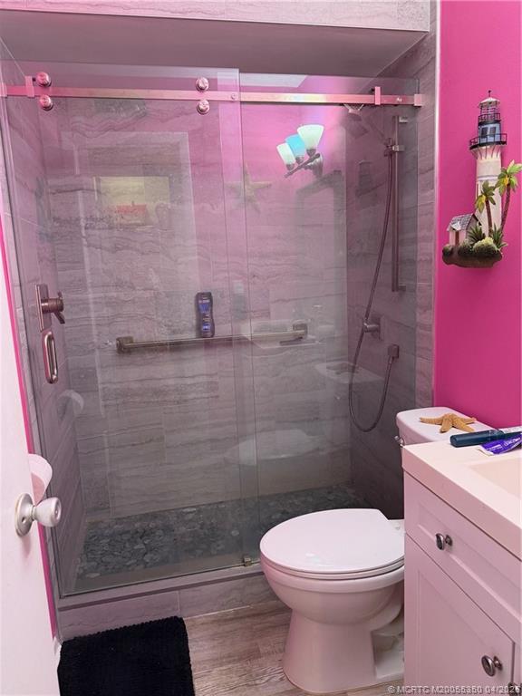 1225 Northwest 21st Street, Unit 3211 Stuart, FL 34994 - Photo 14 of 33 a bathroom with a shower a toilet and a shower