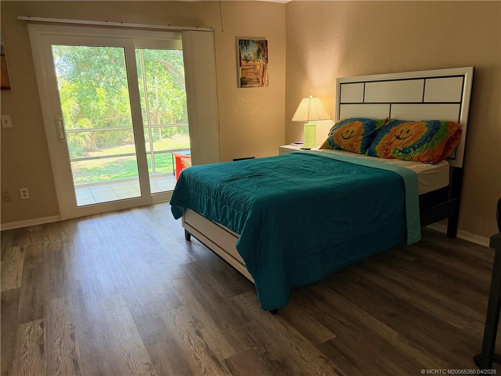 1225 Northwest 21st Street, Unit 3211 Stuart, FL 34994 - Photo 15 of 33 a bedroom with a bed lamp and window