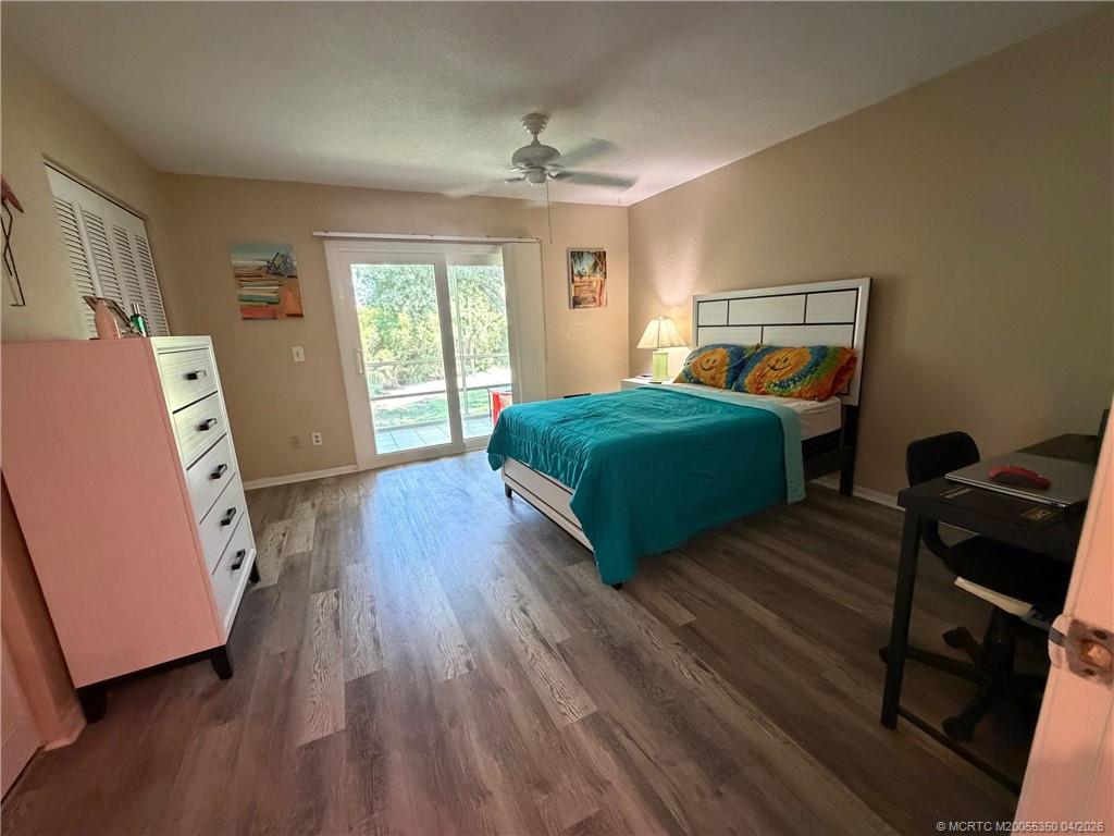 1225 Northwest 21st Street, Unit 3211 Stuart, FL 34994 - Photo 17 of 33 a bedroom with a bed and wooden floor