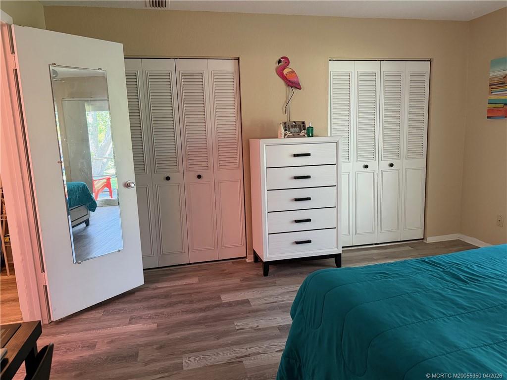 1225 Northwest 21st Street, Unit 3211 Stuart, FL 34994 - Photo 18 of 33 a view of room with closet and wooden floor