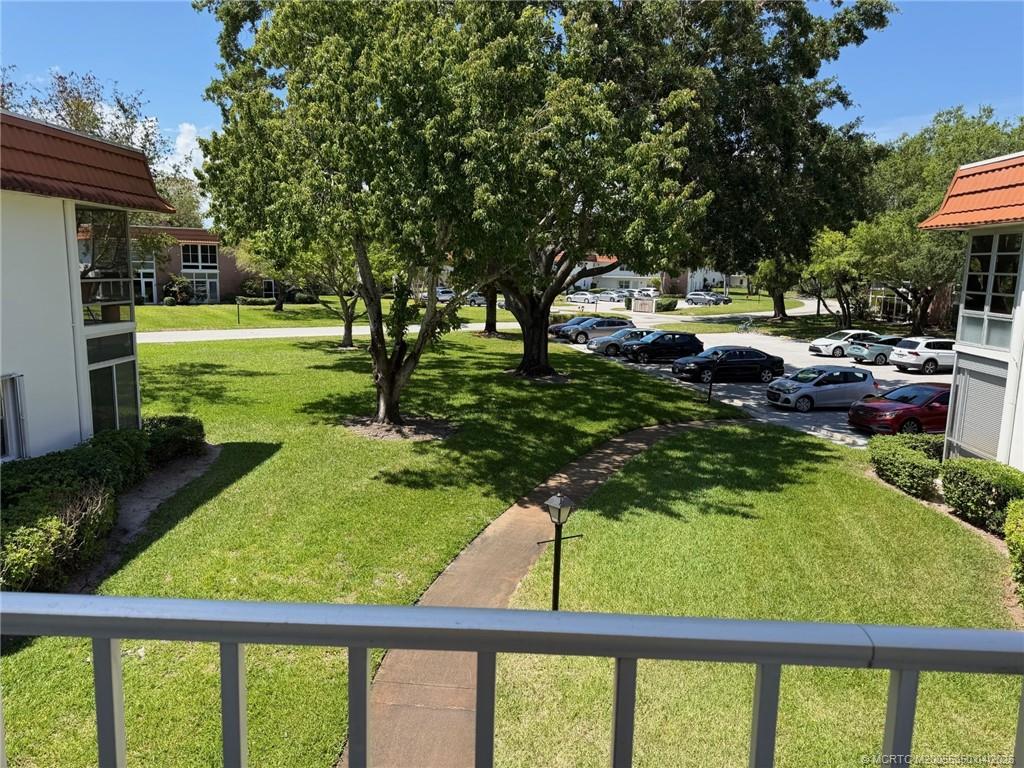 1225 Northwest 21st Street, Unit 3211 Stuart, FL 34994 - Photo 2 of 33 a view of swimming pool from a garden