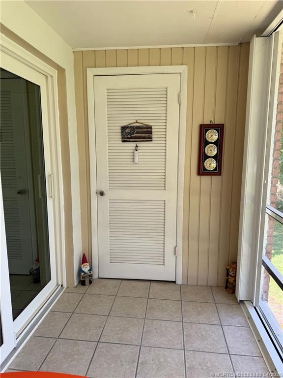 1225 Northwest 21st Street, Unit 3211 Stuart, FL 34994 - Photo 23 of 33 an entryway view with wooden floor and front door