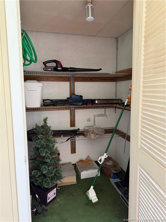 1225 Northwest 21st Street, Unit 3211 Stuart, FL 34994 - Photo 25 of 33 a view of storage and utility room with racks on the wall