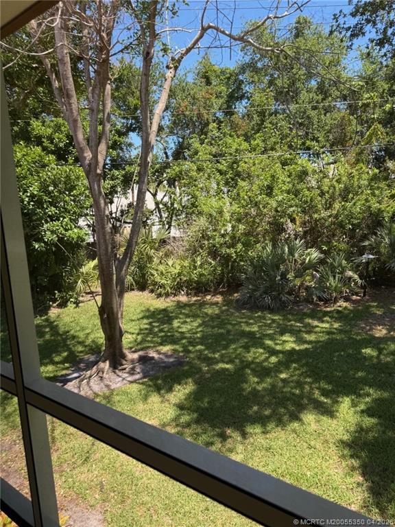 1225 Northwest 21st Street, Unit 3211 Stuart, FL 34994 - Photo 5 of 33 a view of a garden from a window