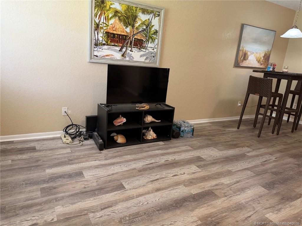 1225 Northwest 21st Street, Unit 3211 Stuart, FL 34994 - Photo 9 of 33 a room with furniture and flat screen tv