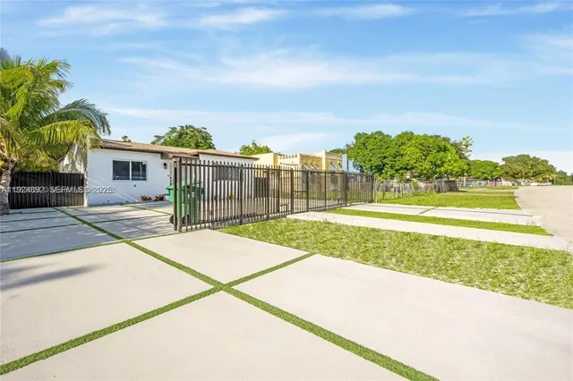 a view of a house with a yard and sitting area