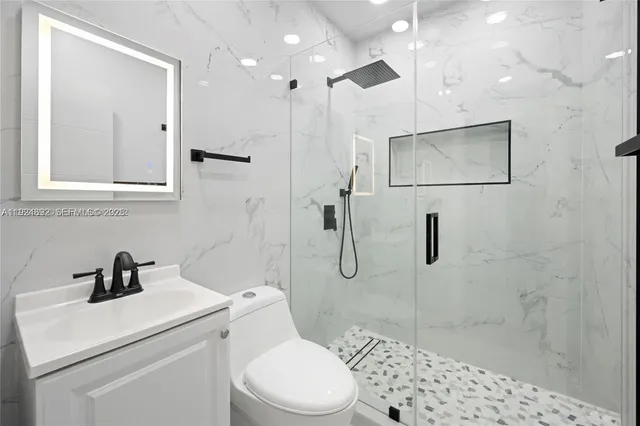 a bathroom with a toilet sink and shower