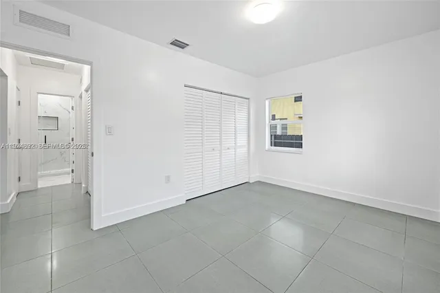 a view of an empty room with a bathroom