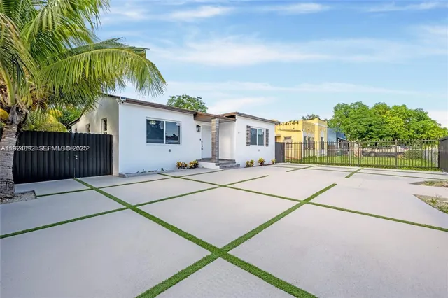 a house with yard and a trees in front of it