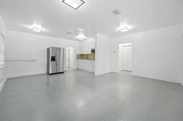a view of a kitchen with a refrigerator and a sink