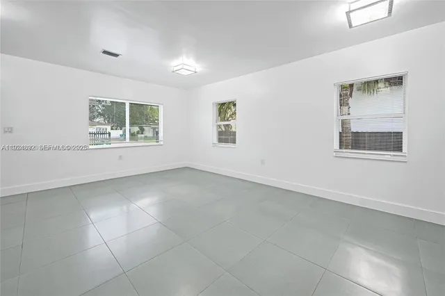 a view of an empty room with a window