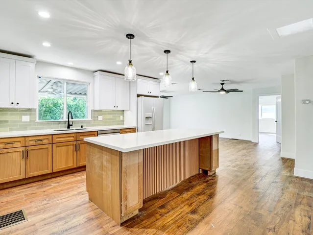 a view of room with a ceiling fan and wooden floor