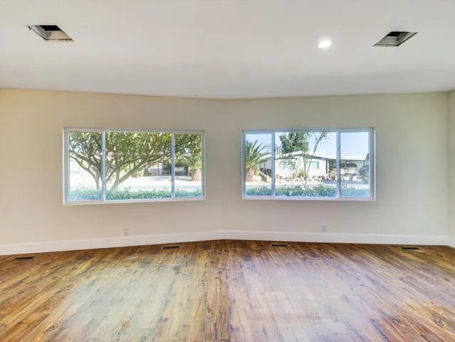 a kitchen with kitchen island granite countertop a sink a counter top space appliances and cabinets