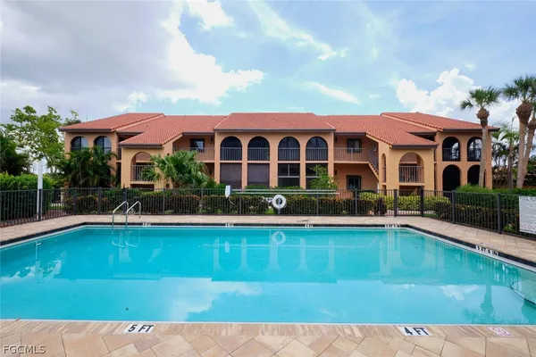 a view of a house with pool plants and large trees
