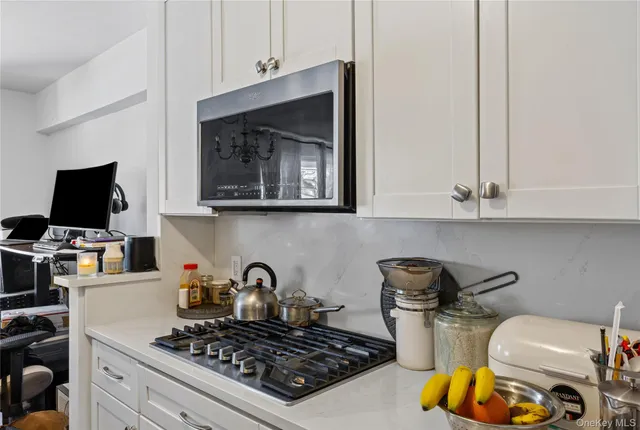 a kitchen with a stove and a microwave