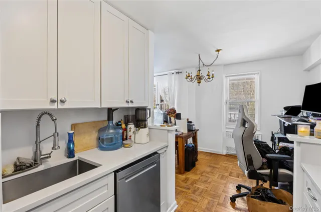 a view of a workspace with furniture and a window