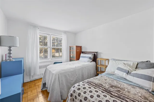 a bedroom with two beds and a window