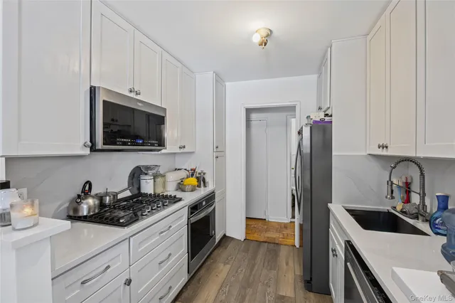 a kitchen with stainless steel appliances a sink stove and refrigerator