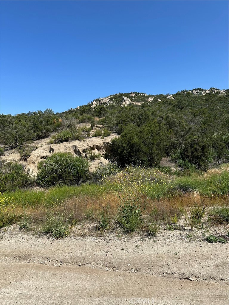 66 Rocky Knoll Road Hemet, CA 92544 - Photo 3 of 11 a view of a road with a building in the background